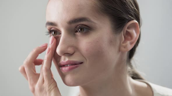 Face Skin Care. Woman Touching Skin Under Eyes Closeup