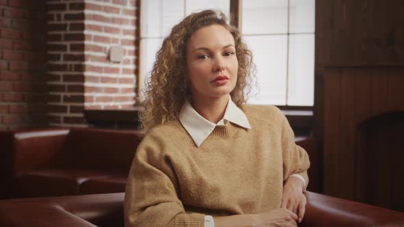 Pivoting Around a Young Caucasian Woman Portrait Looking at Camera Indoors