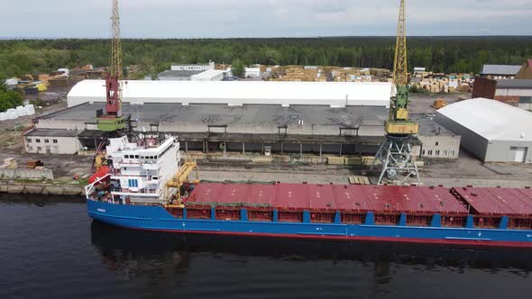 Cargo ship in port with cranes