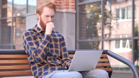 Redhead Beard Young Man Coughing While Working on Laptop Outdoor