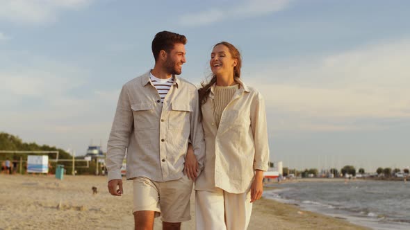 Happy Couple Walking Along Summer Beach