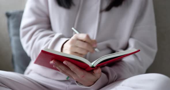 Woman Journalist Makes Notes in Diaries Closeup