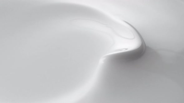 Swirl in milky liquid surface. Slow Motion.