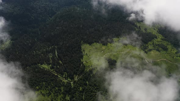 Aerial view of National Park. Flying above the clouds in beautiful mountains. Green hills landscape