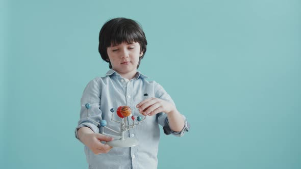 Cute Boy with Solar System Model Toy