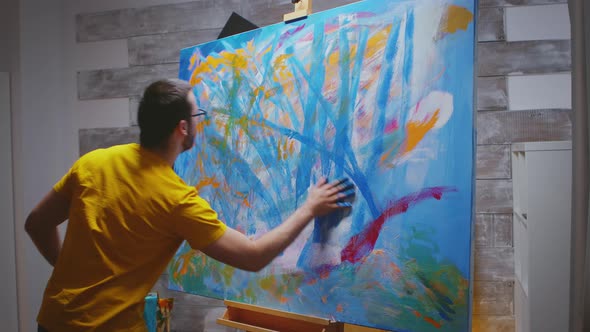 Artist Paints on Large Canvas