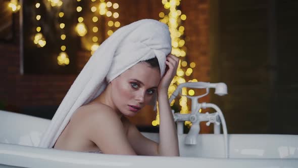 Wet Lady Posing at Camera in a Bath with Towel on Head Slowly