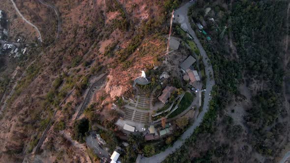 Aerial top down spinning over Sanctuary of the Immaculate Conception and statue in San Cristobal Hil