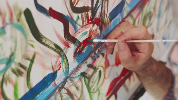 Closeup of Hand Male Paint Artist Drawing an Abstract Painting on Canvas with Brush