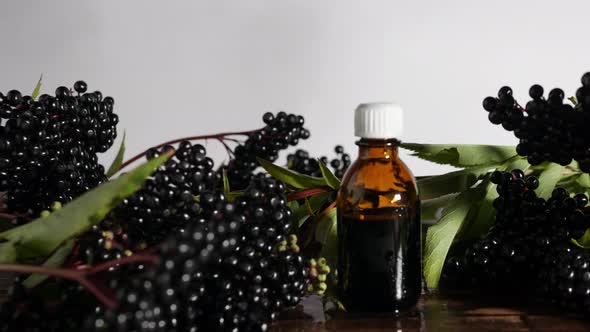 Medicine In A Jar On A Wooden Board, A Bottle Of Medicine From A Black Berry. Elderberry Homeopathy