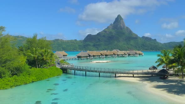 Aerial drone view of a luxury resort and overwater bungalows in Bora Bora tropical island