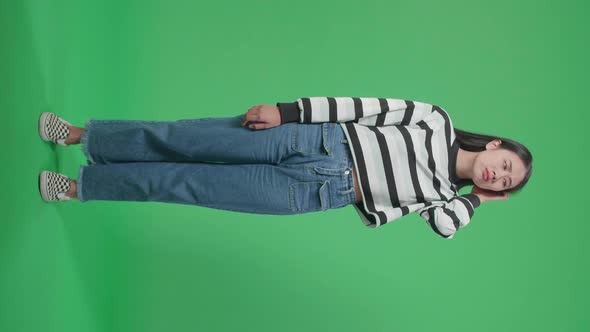 Full Body Of A Puzzled Asian Woman Is Standing In Front Of Green Screen Background