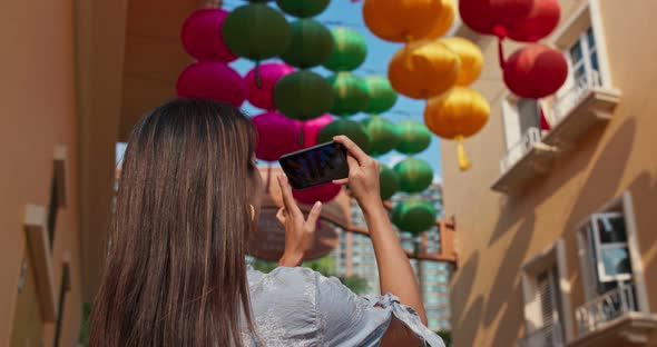 Woman take photo on cellphone with chinese lantern at outdoor