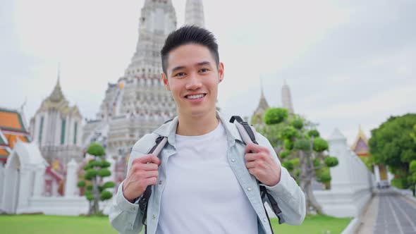 Portrait of Asian attractive man backpacker travel in beautiful city.