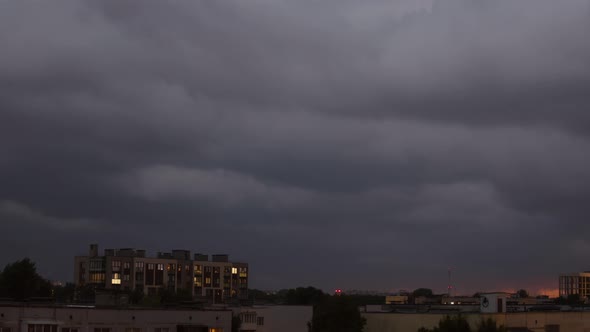 Timelapse of storm clouds over city alt