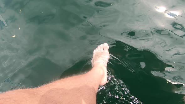 Relaxing with my feet in the lake off a boat