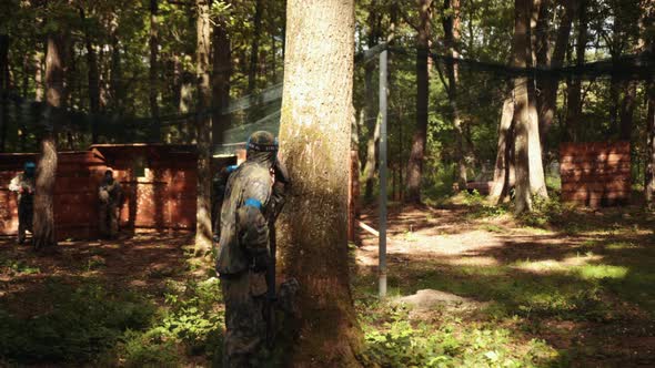 Men Wears Camouflage and Protective Mask While Participating in a Paintball Battle Game