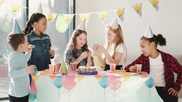 Group of Children Celebrating Birthday Party at Decorated Home