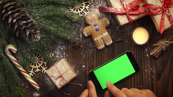 Look From Above Smartphone Green Screen Lying Among Christmas Cookies Fir Branches Present Packages