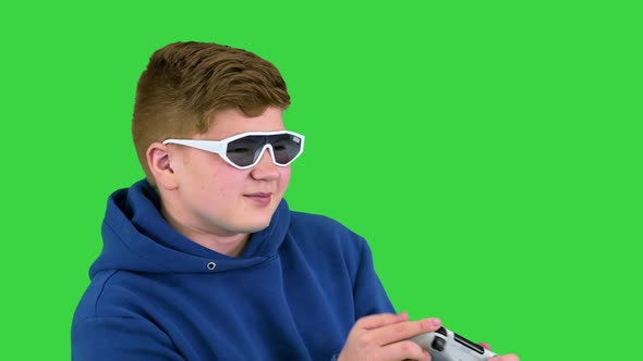 Teenager Actively Playing Video Game on a Green Screen Chroma Key