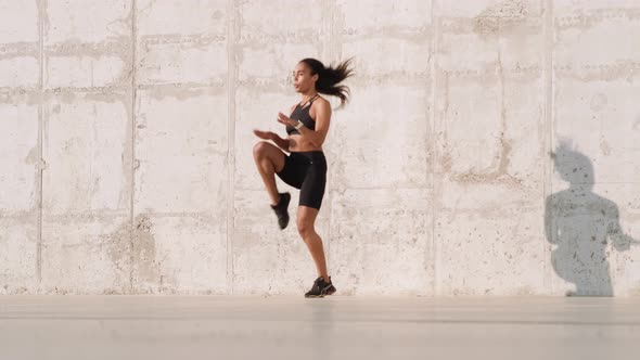 A good looking african american woman jumping while training