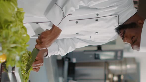 Vertical Video Portrait of African American Cook in Uniform Making Meal Preparations