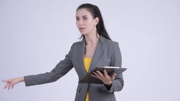 Young Beautiful Businesswoman Directing While Holding Clipboard