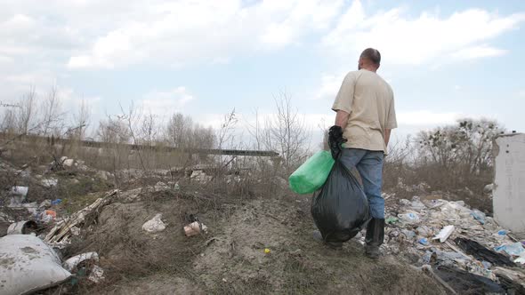 Male Standing on the Hill at Garbage Dump Site
