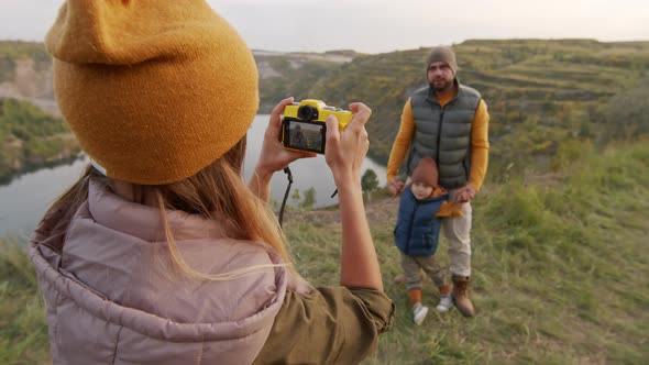 Woman Taking Photos of Man and Little Boy on Hike
