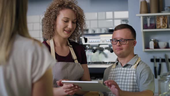 Caucasian man with down syndrome learning how to take orders. Shot with RED helium camera in 8K.