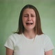 Pretty Woman in Tshirt Cries Loudly with Grimace on Green - VideoHive Item for Sale