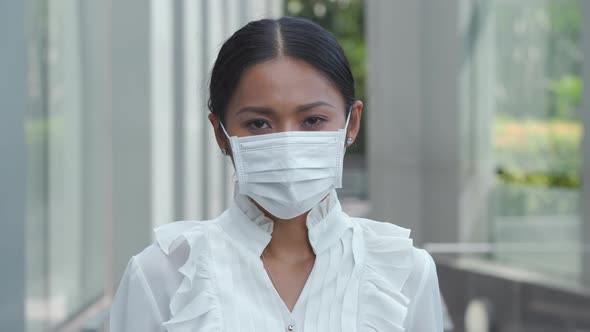 Asian women wear masks to protect against the virus.