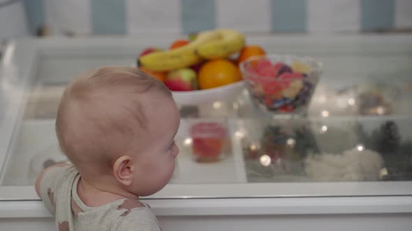 Cute Kid Trying to Get a Fruit Platter From the Table 10Monthold Toddler Learning to Walk Exploring