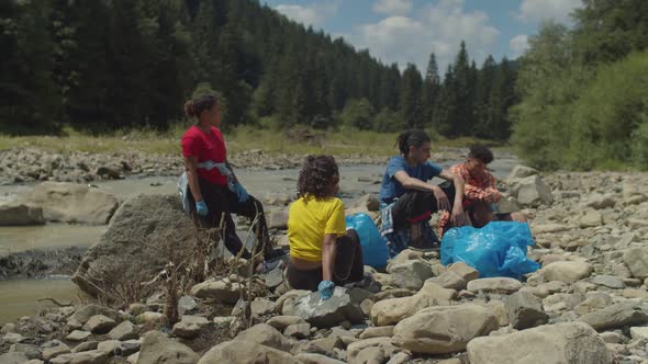 Portrait of Exhausted Eco Friendly Multiethnic People Relaxing After Environmental Cleanup