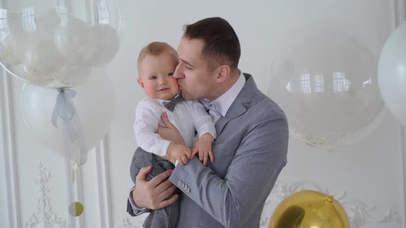 Father Holding on Hands Infant Small Child