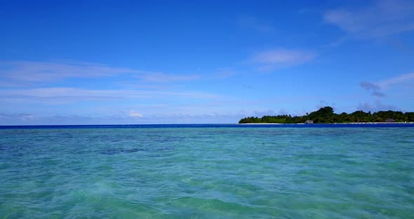 Wide birds eye abstract shot of a sandy white paradise beach and aqua turquoise water background in 