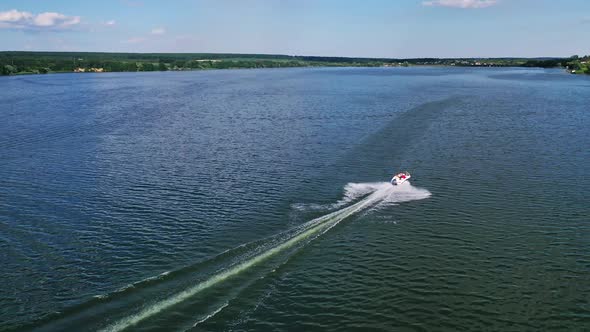 Boat floating on the river. Aerial drone view of small motor boat floating on river