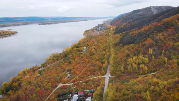 Aerial View. Autumn, a Large River Among the Forest Hills. The Trees Are Already in Yellow and