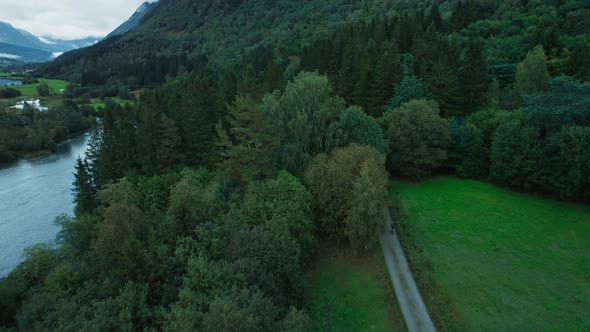 Scenic Drone View on Cyclists Team on Nordic Road
