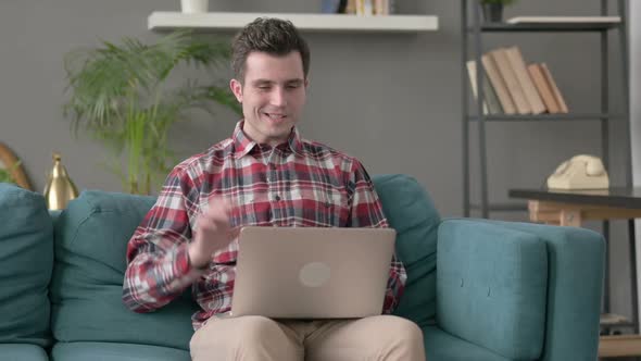 Man Doing Video Call on Laptop on Sofa