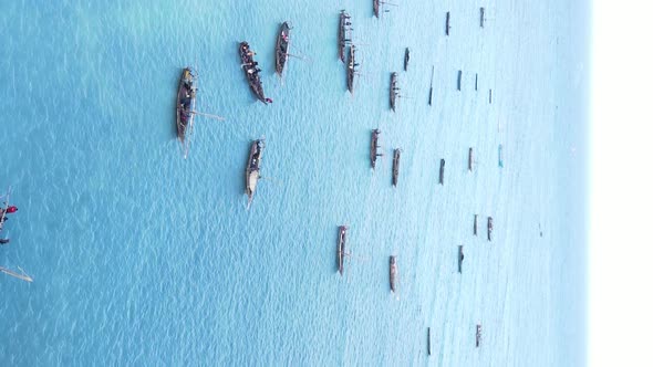 Vertical Video Boats in the Ocean Near the Coast of Zanzibar Tanzania Aerial View