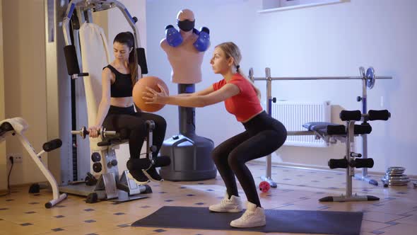 Side View of Young Confident Woman Doing Squats As Slender Caucasian Millennial Working Out at