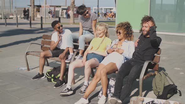 Content Multiethnic Friends on Street Bench