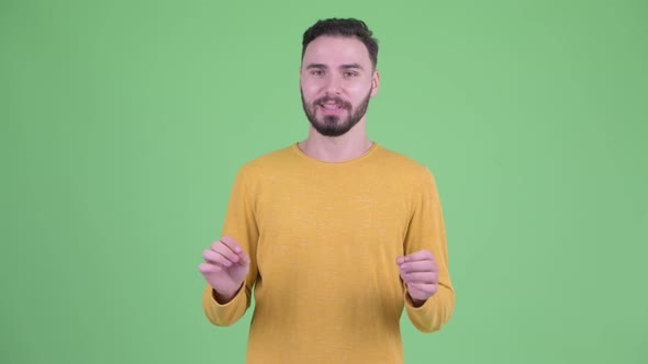 Happy Young Handsome Bearded Man Being Interviewed and Looking Excited