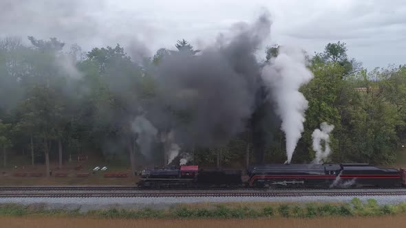 Aerial Side View of a Two Steam Locomotives Double Heading a Freight Train