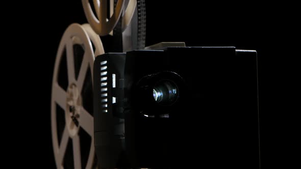 Projection Lens in Which Changes the Picture. Studio Black Background