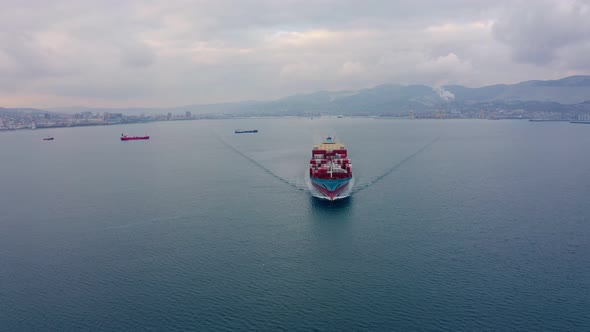 Aerial Footage of Ultra Large Container Cargo Ship at Sea, Front View