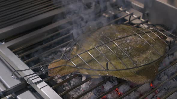 Grilled turbot with garlic and butter sauce, lemon and aromatic herbs