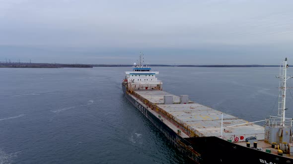 4K aerial footage of a cargo ship crossing the Beauharnois Canal in the St Lawrence Seaway, Canada.