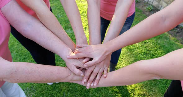 Group of women forming handstack in the garden 4k